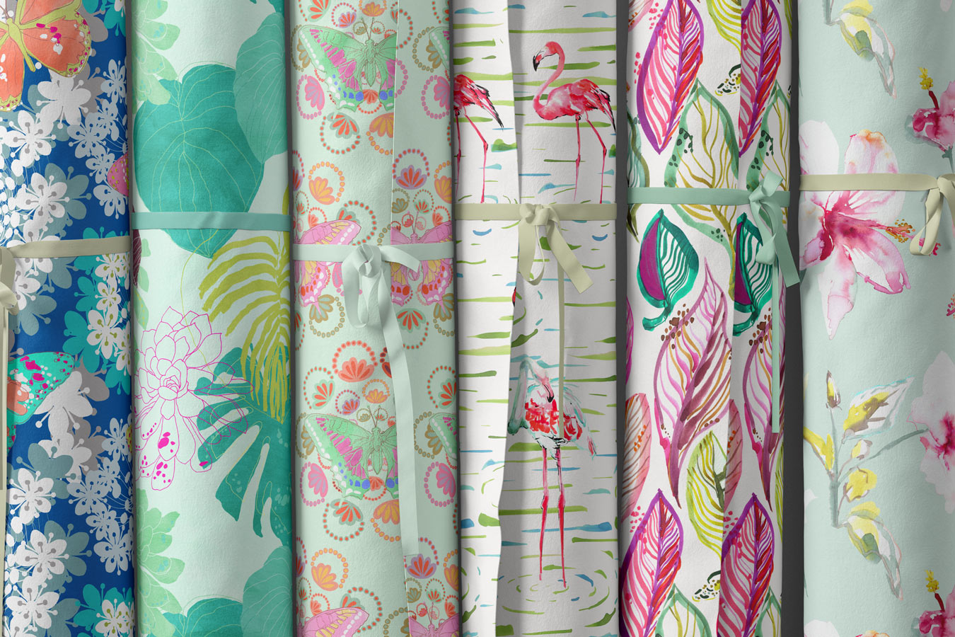 sandra banava selection of new fabric designs showing tropical leaves flamingos pink and green leaves and butterflies in a painterly modern watercolor style